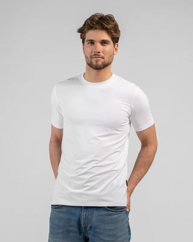 Man wearing a plain white t-shirt and blue jeans on a gray background