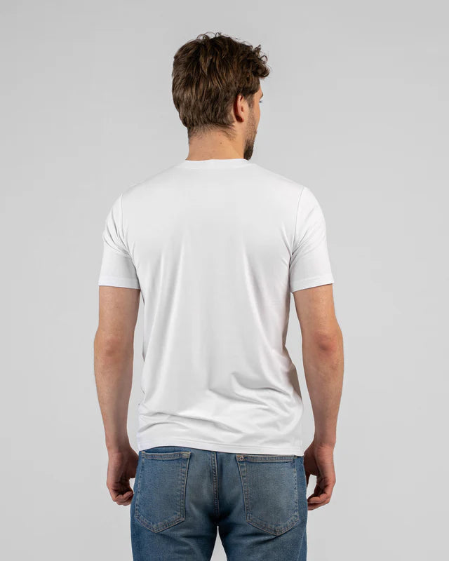 Man wearing a plain white t-shirt and blue jeans on a light gray background