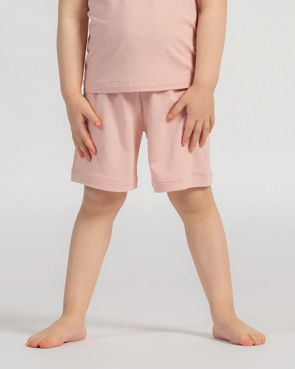Person wearing pink shorts on a plain background