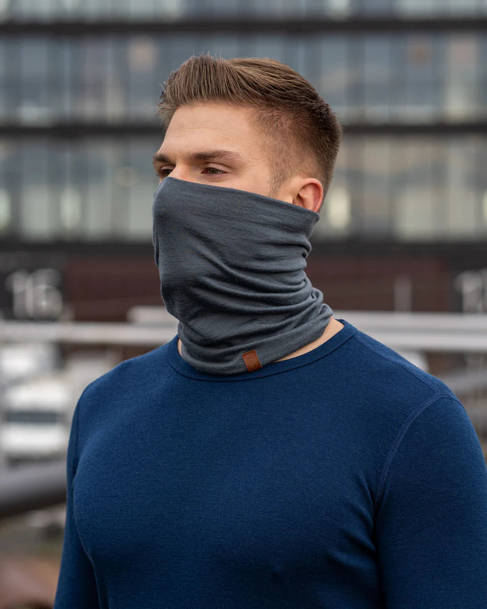 Man wearing a gray neck gaiter in an urban setting