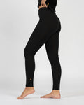 Person wearing black leggings on a white background