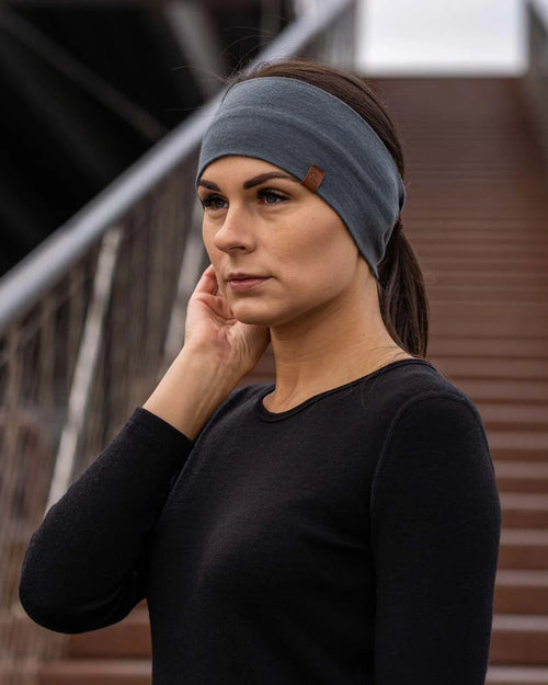 Woman wearing a blue headband outdoors on a staircase