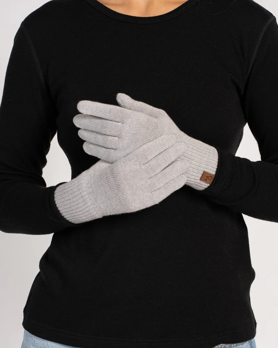 Person wearing black long-sleeve shirt and gray gloves on a light gray background