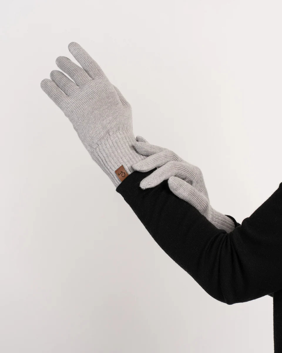 Gray gloves worn on a white background