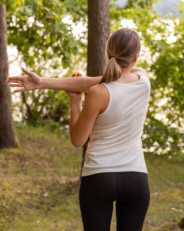 Woman stretching outdoors in a natural setting