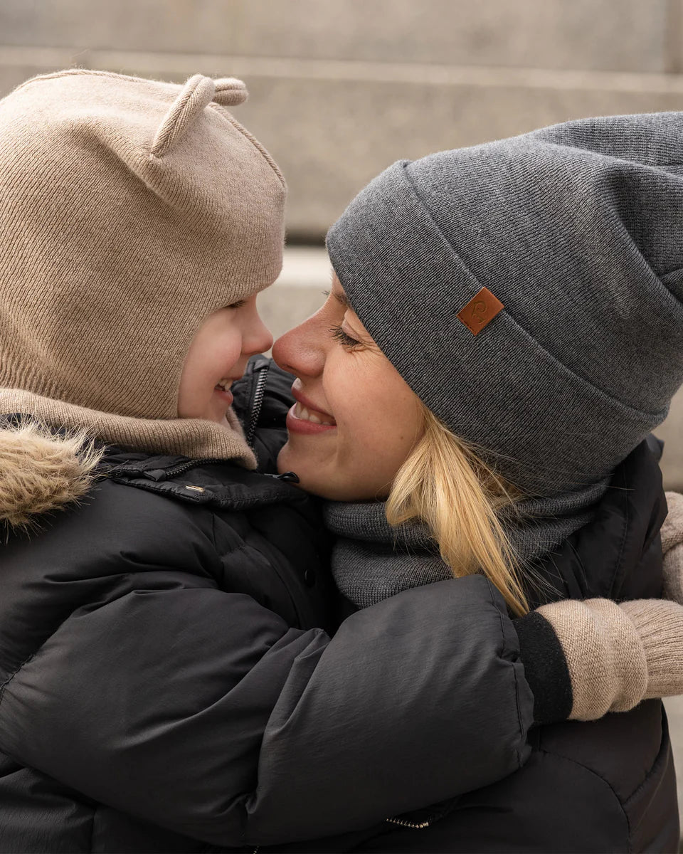 Woman wearing a dark gray knitted merino beanie outdoors