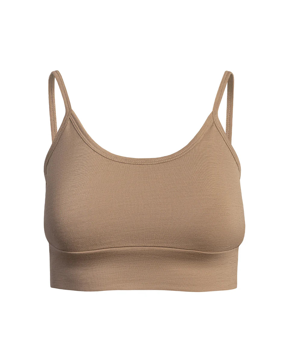 Beige sports bra with thin straps on a white background